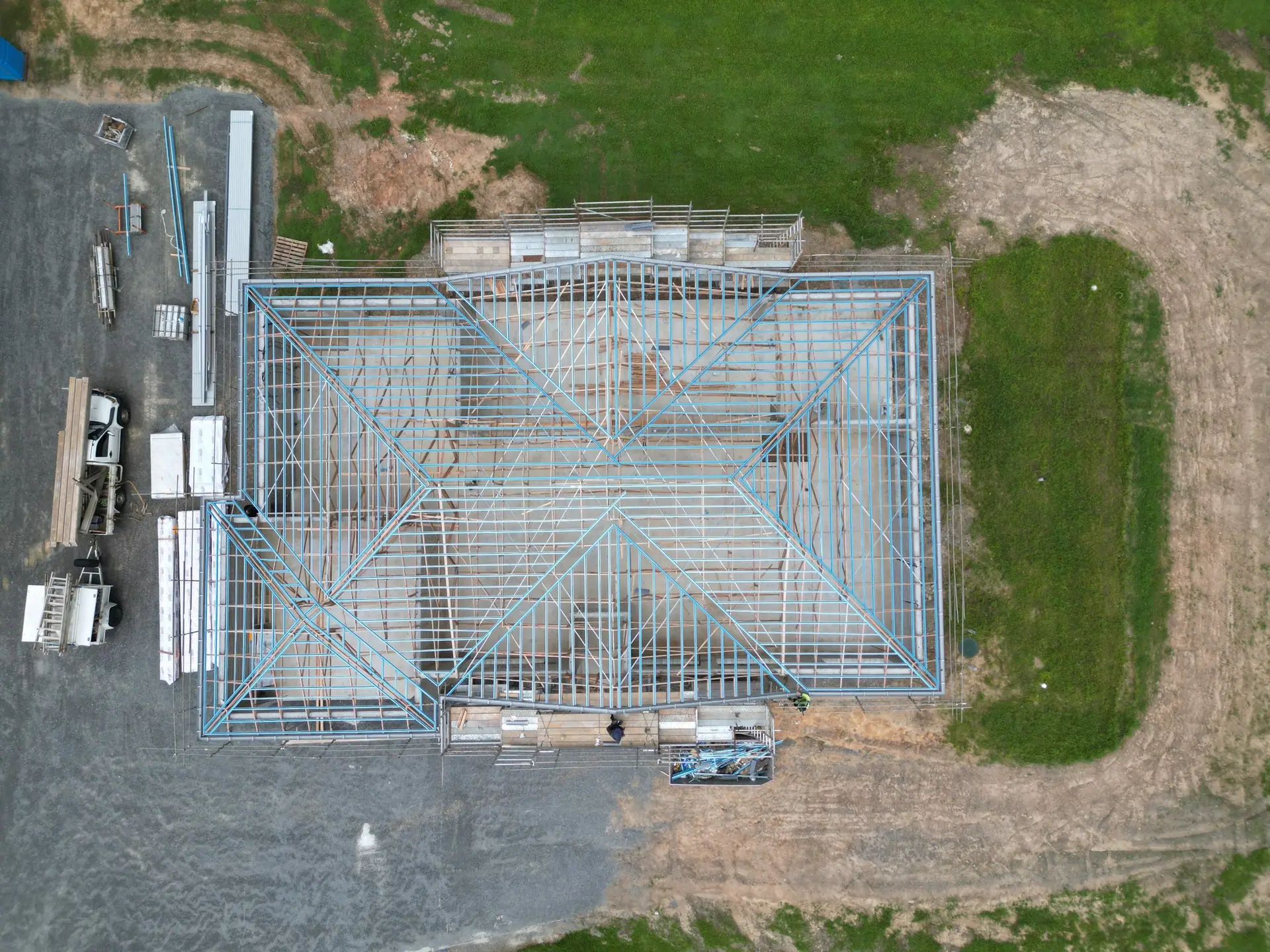 Aerial view of a new home's steel roof framing ready for sheeting